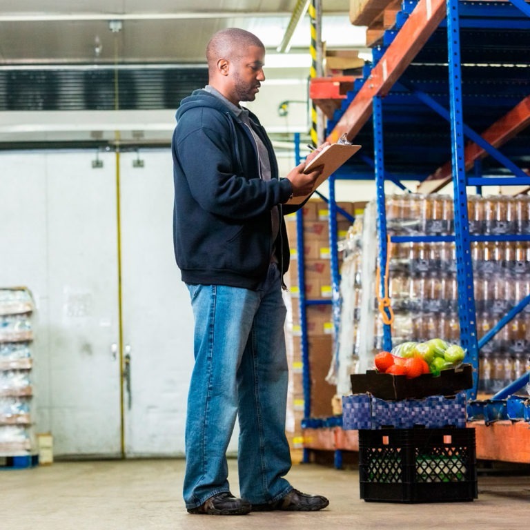 Worker counting inventory on food and beverage logistics