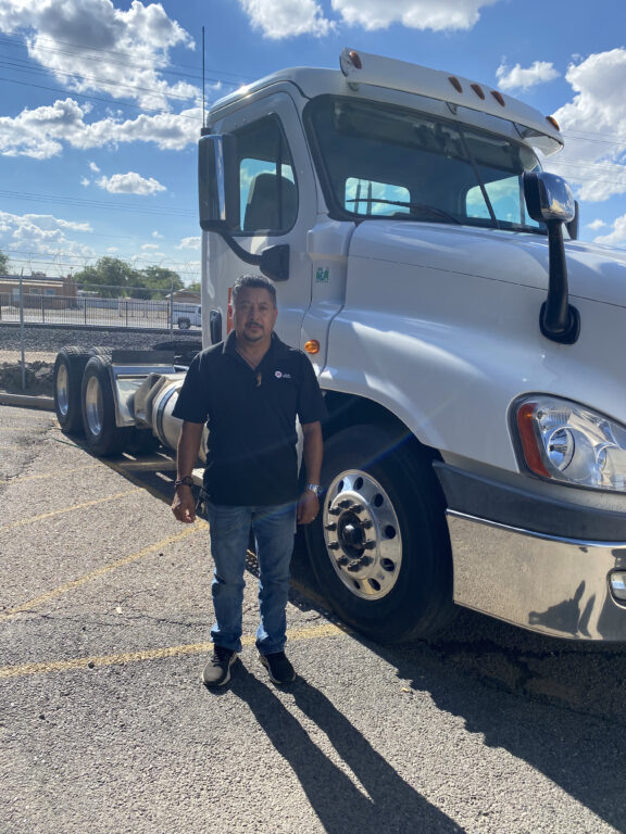 Hub Group employee standing in front of his truck