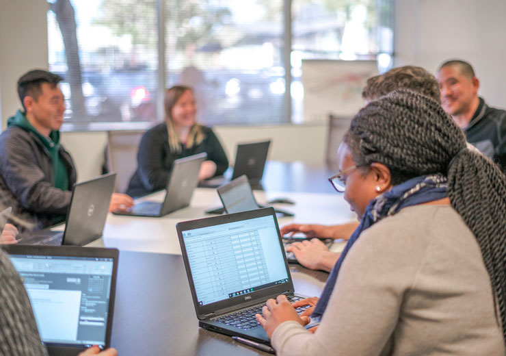 Employees working in Hub Group conference room