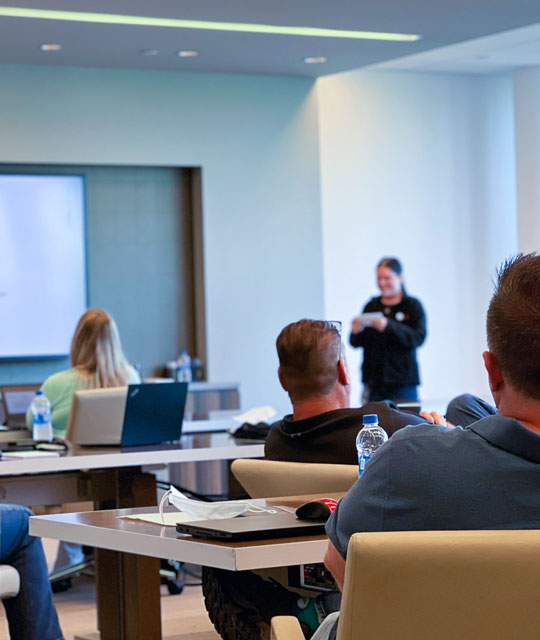Woman presenting in front of Hub Group conference room
